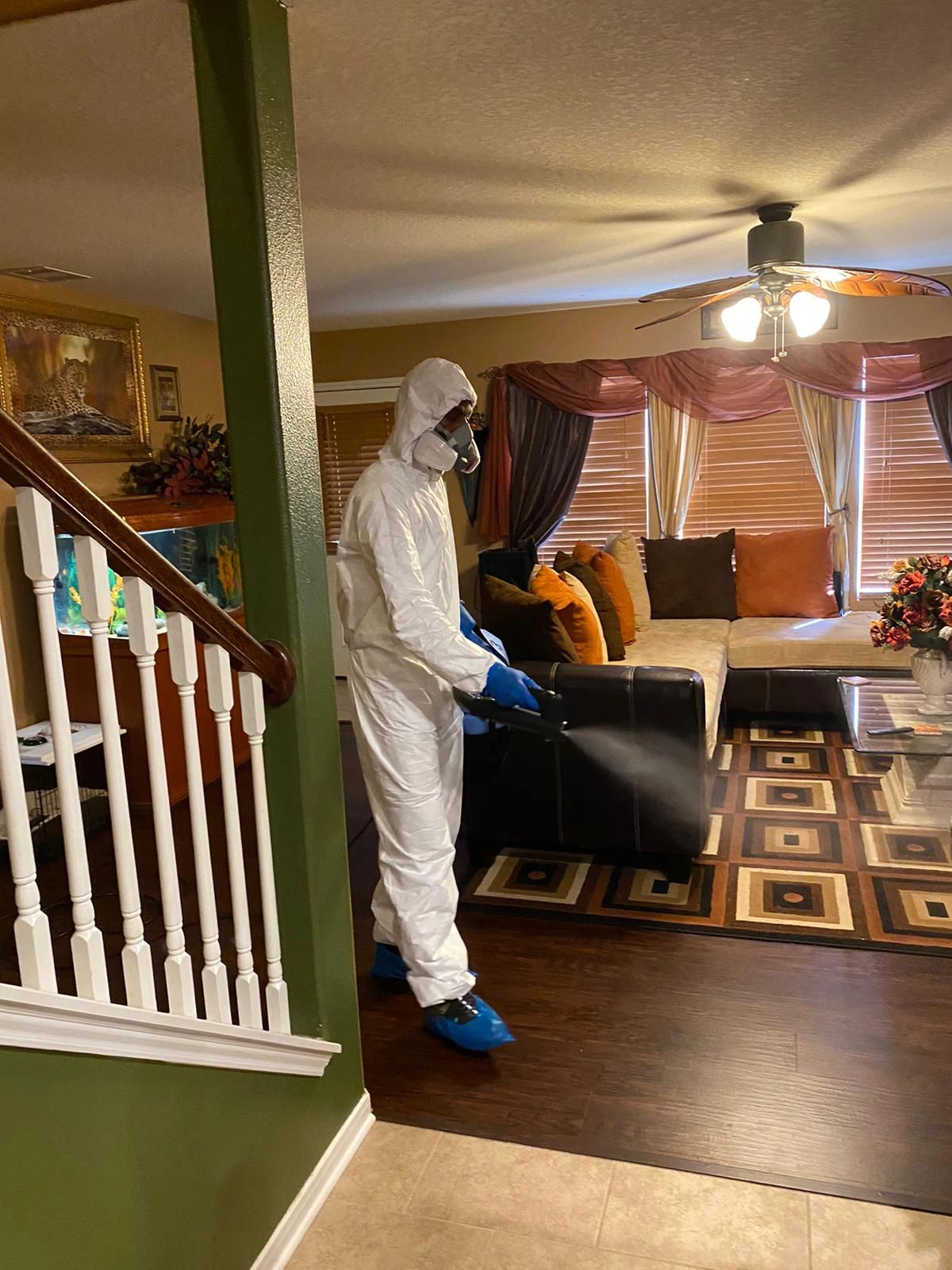 A technician using cleaning equipment in a room